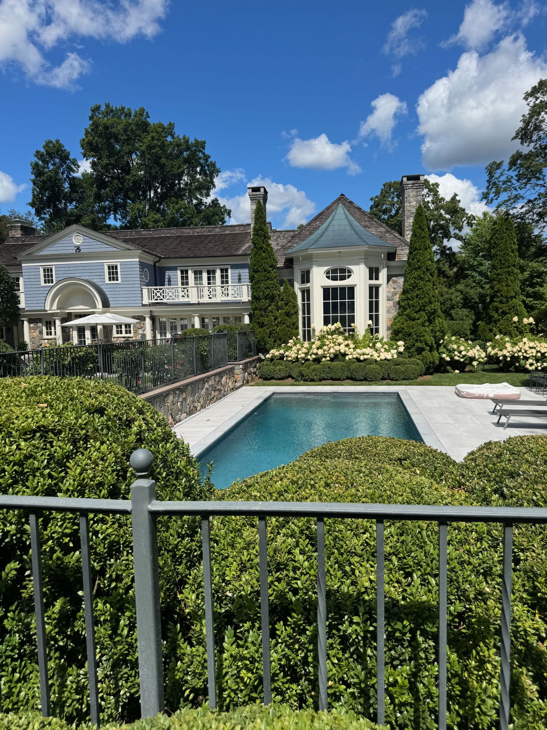 Estate pool with manicured hedges
